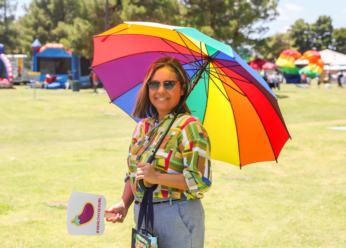 Sharron Courtney cools down underneath an umbrella at the 3rd annual LGBTQ Henderson Pride Fest ...