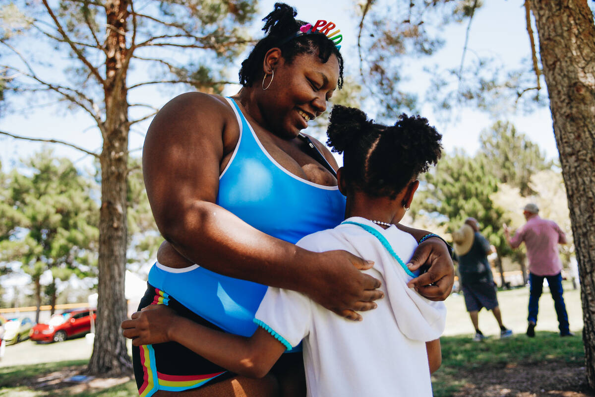 Acacia Dorsey, left, hugs their daughter, Khalia Dorsey, 6, during Henderson Pride Fest on Satu ...