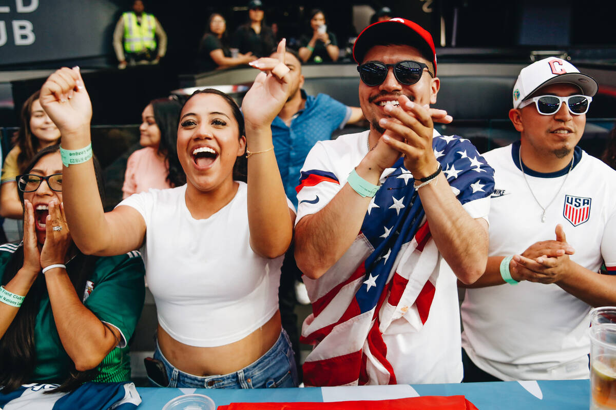Danya Rodriguez, left, and Luis Chavez cheer for Team USA as the team enters the arena during t ...