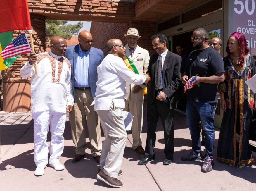 Members of the Ethiopians community wave Ethiopian and American flags as they congratulate one ...