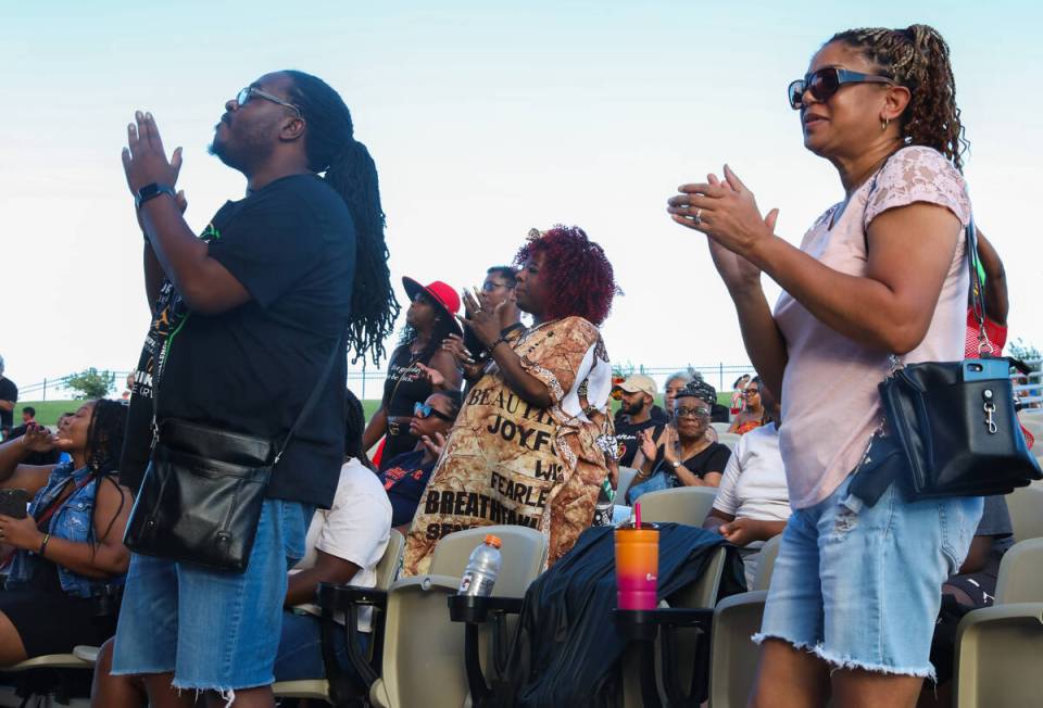 A crowd of people sing and dance along to performers at the F.A.I.T.H Juneteenth Freedom Festiv ...