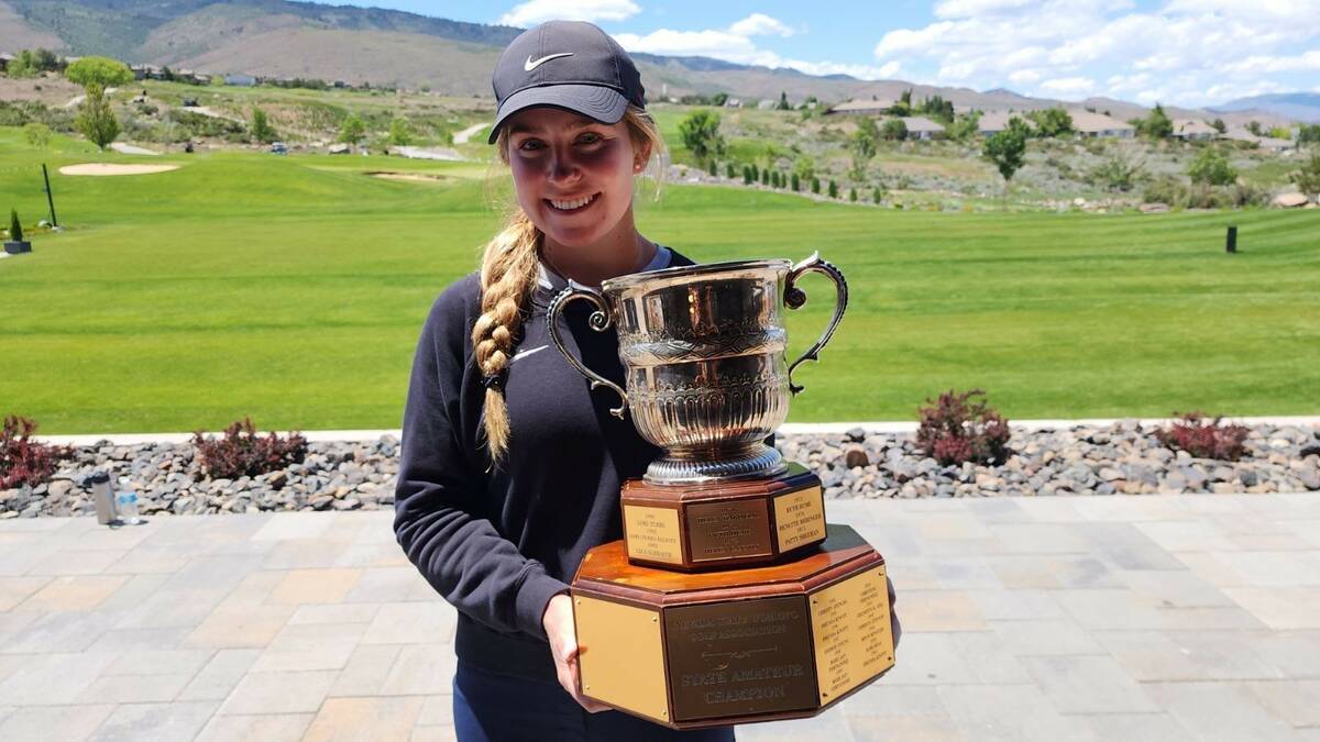 Audrey Brust holds the championship trophy after winning the Nevada State Women's Amateur at Th ...