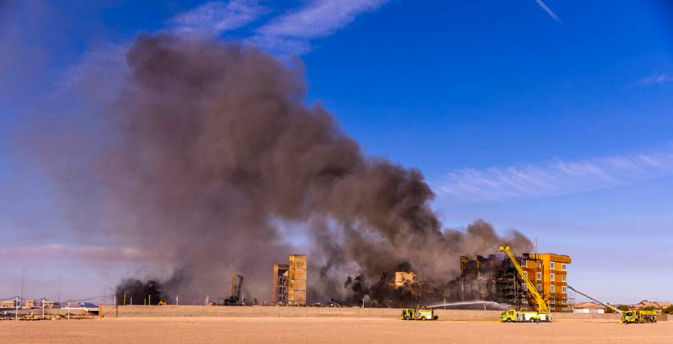 Firefighters work to extinguish a blaze at an under-construction residential complex near Buffa ...