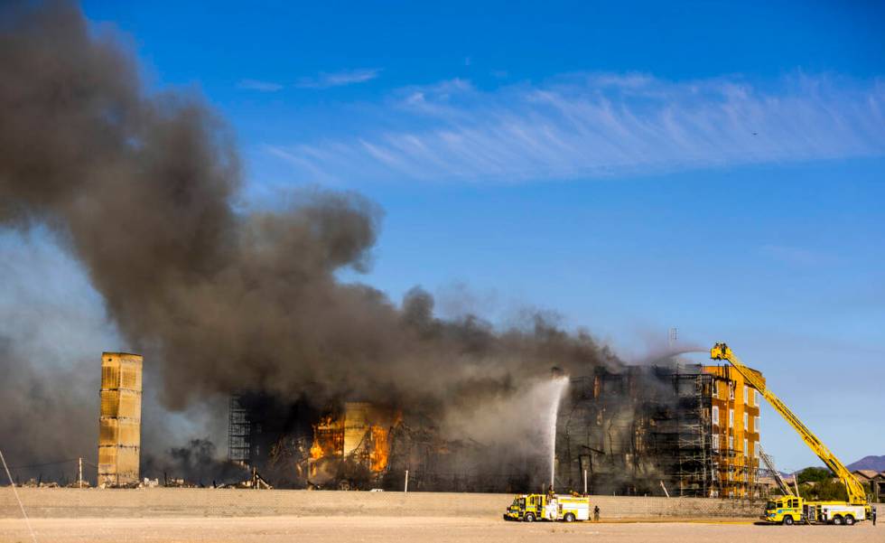 Firefighters work to extinguish a blaze at an under-construction residential complex near Buffa ...