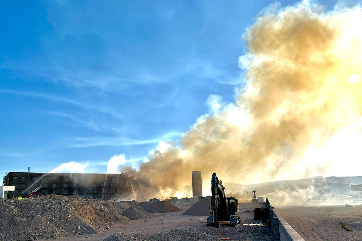 Firefighters work to extinguish a blaze at an under-construction residential complex near Buffa ...