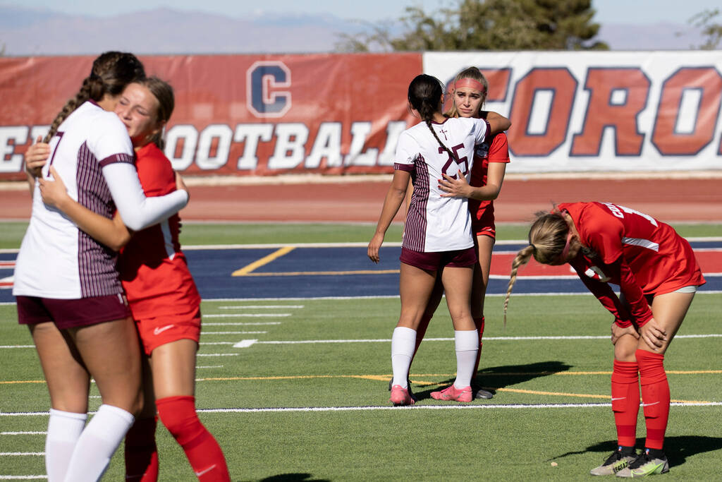 Faith Lutheran players console disappointed Coronado players after they beat them in the Class ...