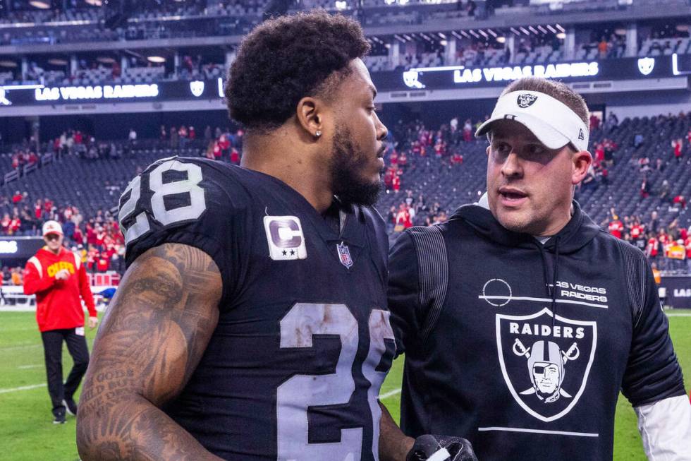 Raiders running back Josh Jacobs (28) and Head Coach Josh Jacobs talk on the way off the field ...