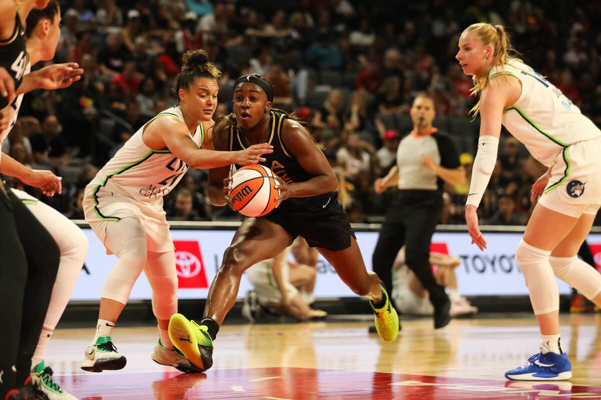 Las Vegas Aces guard Jackie Young (0) drives the ball down the court during a game against the ...