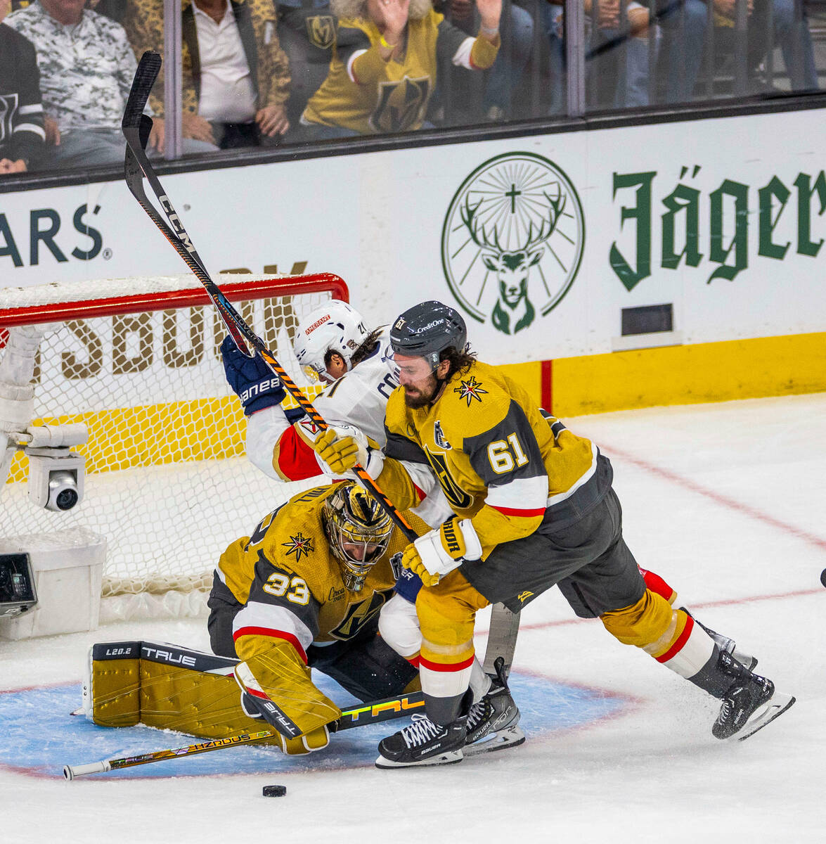 Golden Knights right wing Mark Stone (61) drives Florida Panthers center Nick Cousins (21) away ...