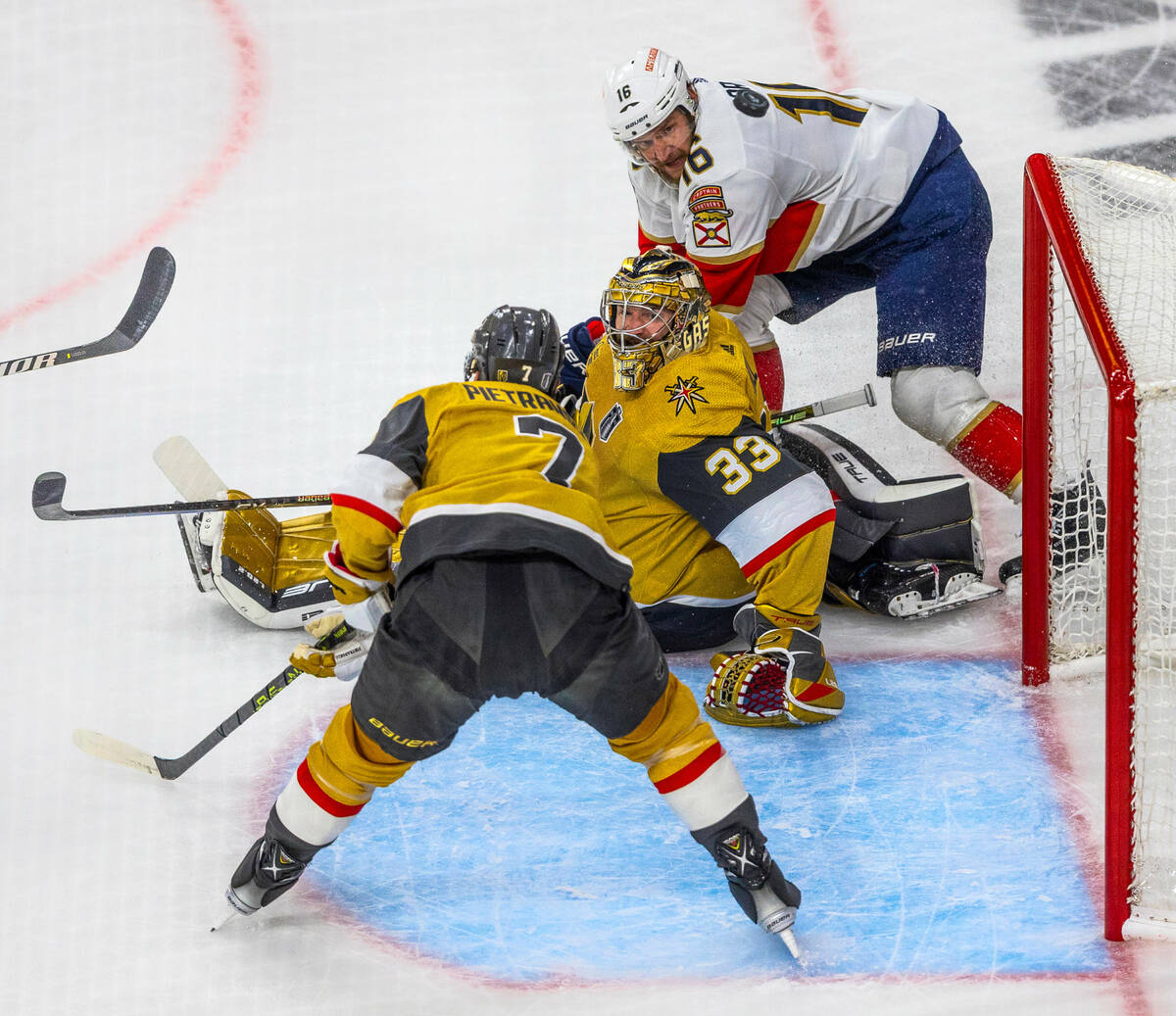 Golden Knights goaltender Adin Hill (33) and defenseman Alex Pietrangelo (7) look to a deflecte ...