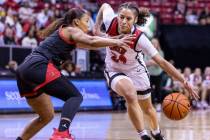 UNLV guard Essence Booker (24) drives the land against San Diego State guard Asia Avinger (1) d ...