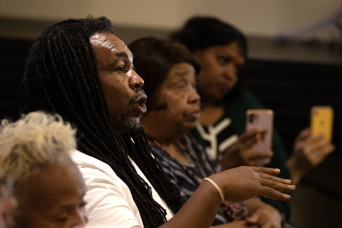 Corey Johnson, a Windsor Park neighborhood resident, asks questions during a community meeting ...