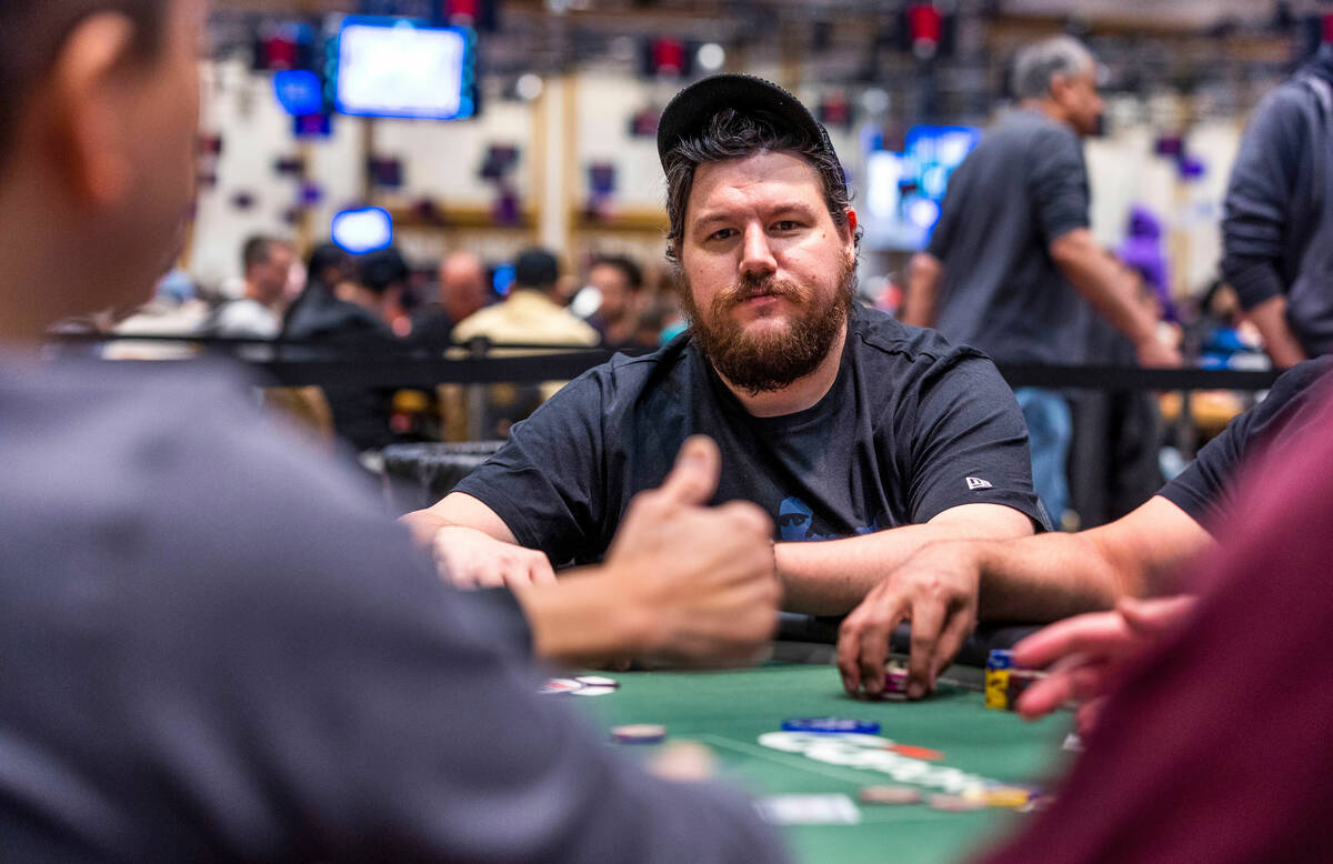 Poker player Shaun Deeb watches another player make a decision at his table during the WSOP in ...