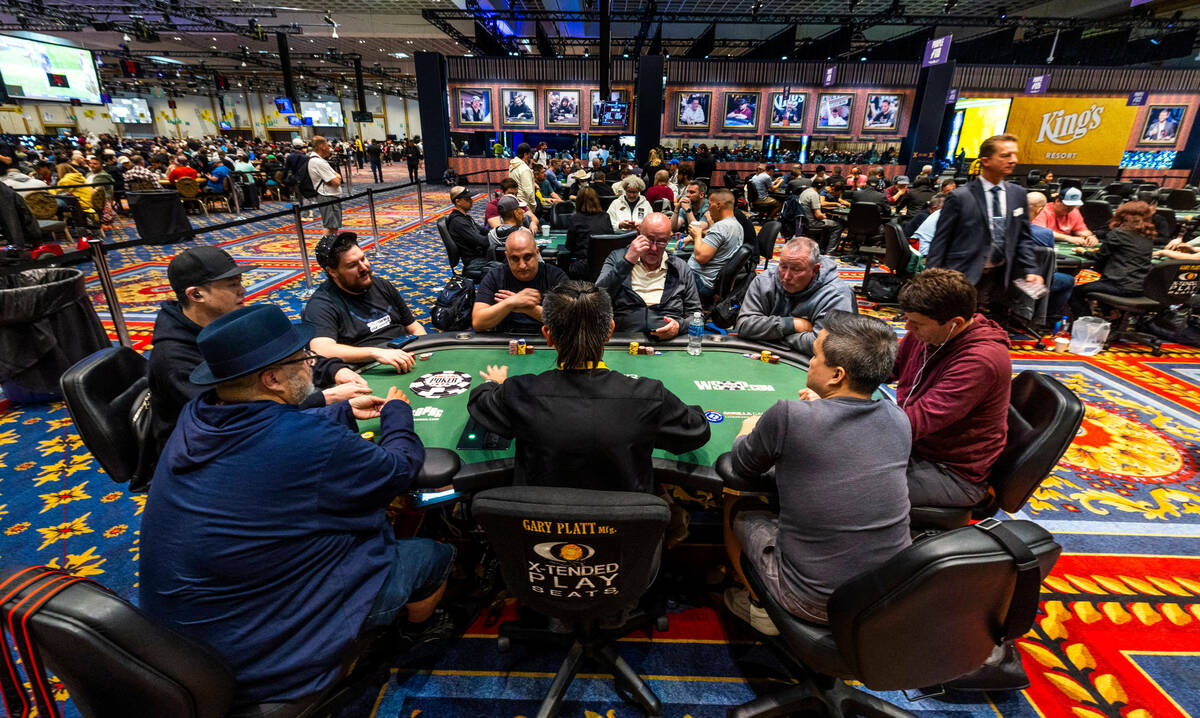 Poker player Shaun Deeb, left, watches the action at his table during the WSOP in the Paris on ...