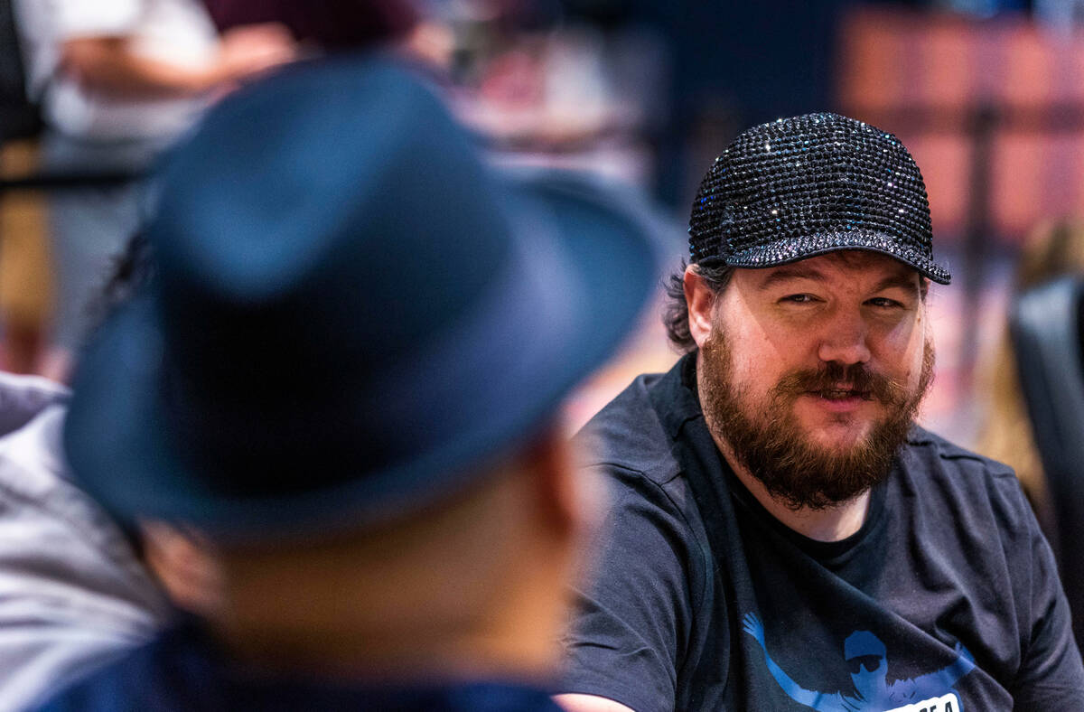 Poker player Shaun Deeb chats with another player at his table during the WSOP in the Paris on ...