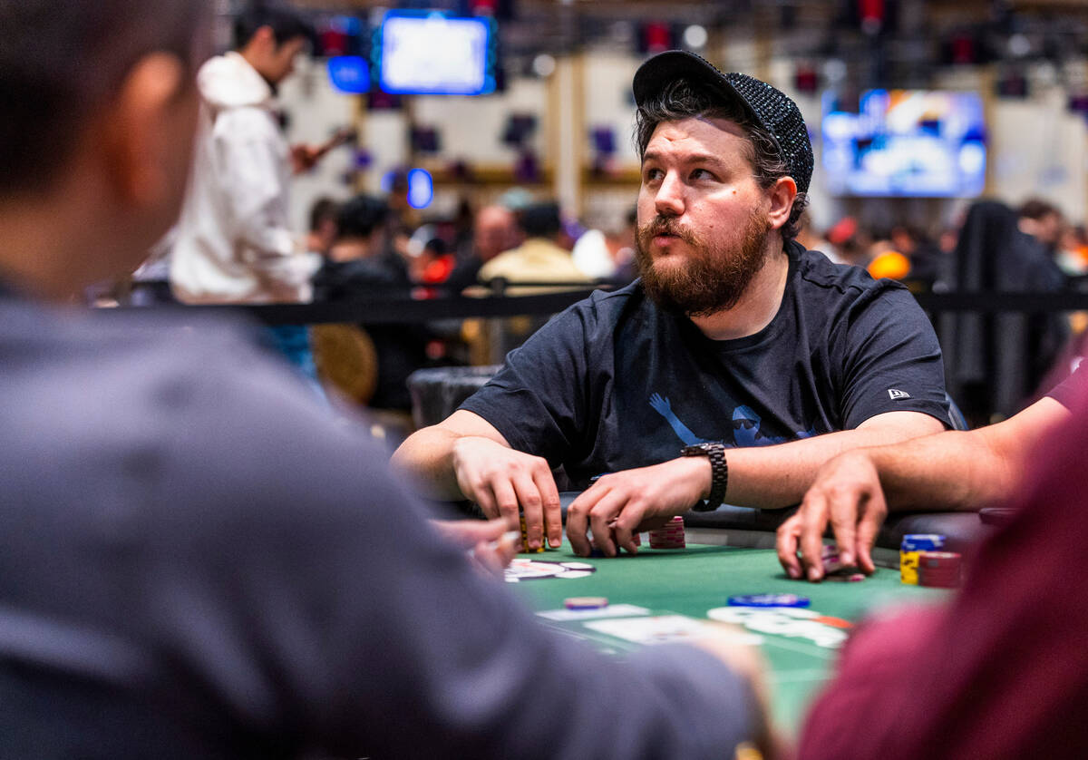 Poker player Shaun Deeb waits for other players to decide on their hands at his table during th ...