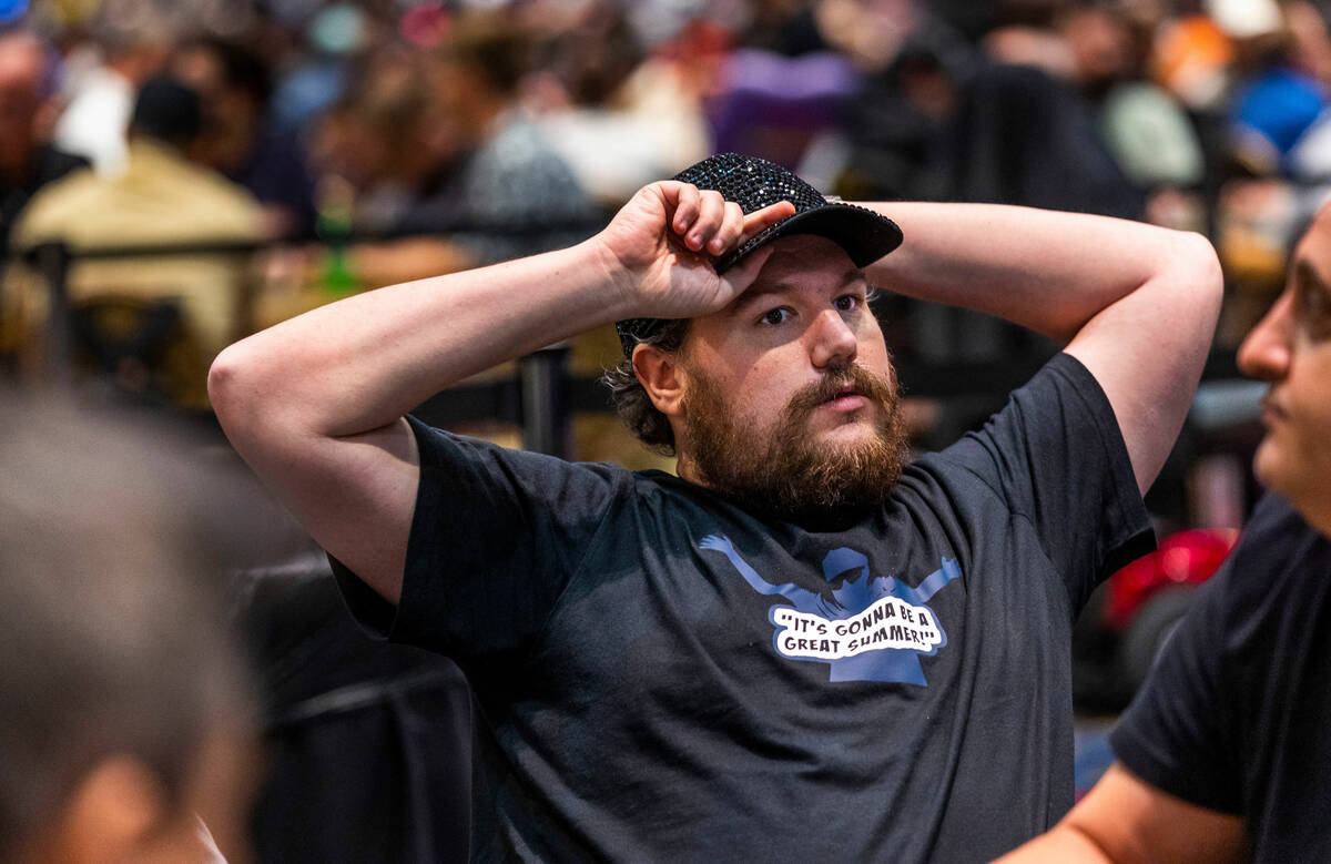Poker player Shaun Deeb sits back and considers his hand at his table during the WSOP in the Pa ...