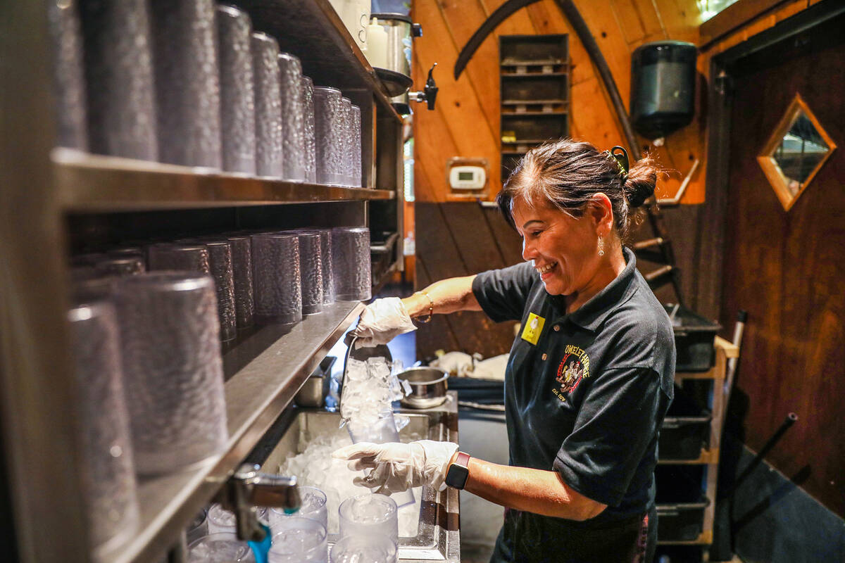 Hostess Jean Vallejera refills drinks at The Omelet House at their central Las Vegas location, ...