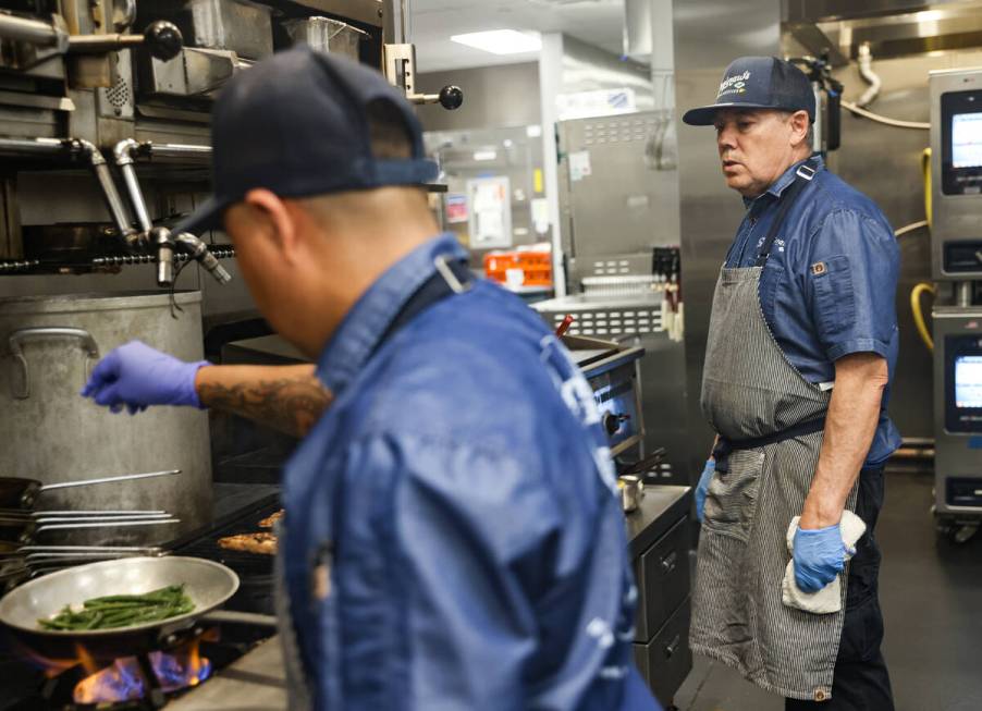 Pedro Maldonado, left, cooks as Juan Lujna, right, looks on in the kitchen at Saginaw’s ...