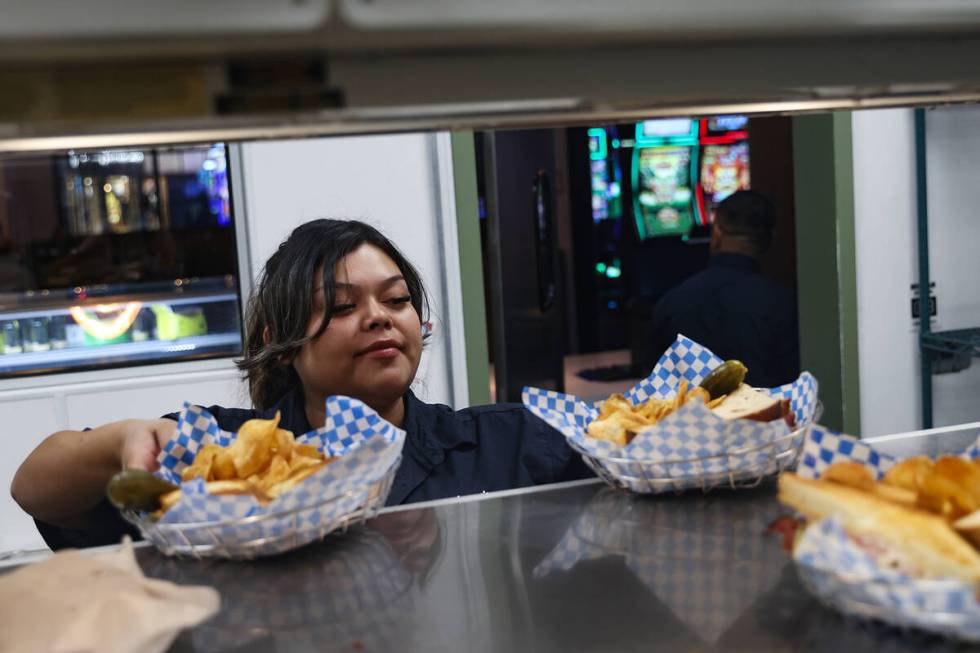 Mayra Rosales picks up food to bring to customers at Saginaw’s Deli at Circa hotel-casin ...