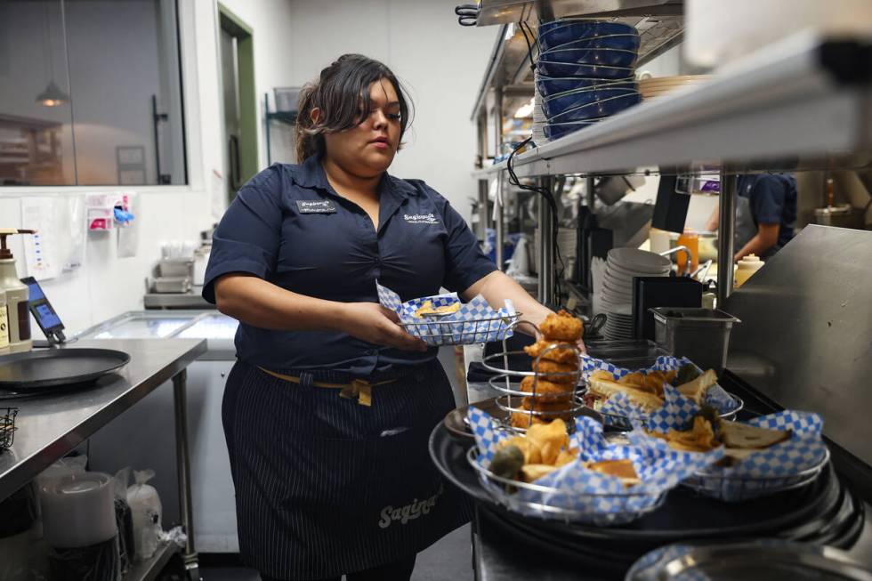 Mayra Rosales picks up food to bring to customers at Saginaw’s Deli at Circa hotel-casin ...