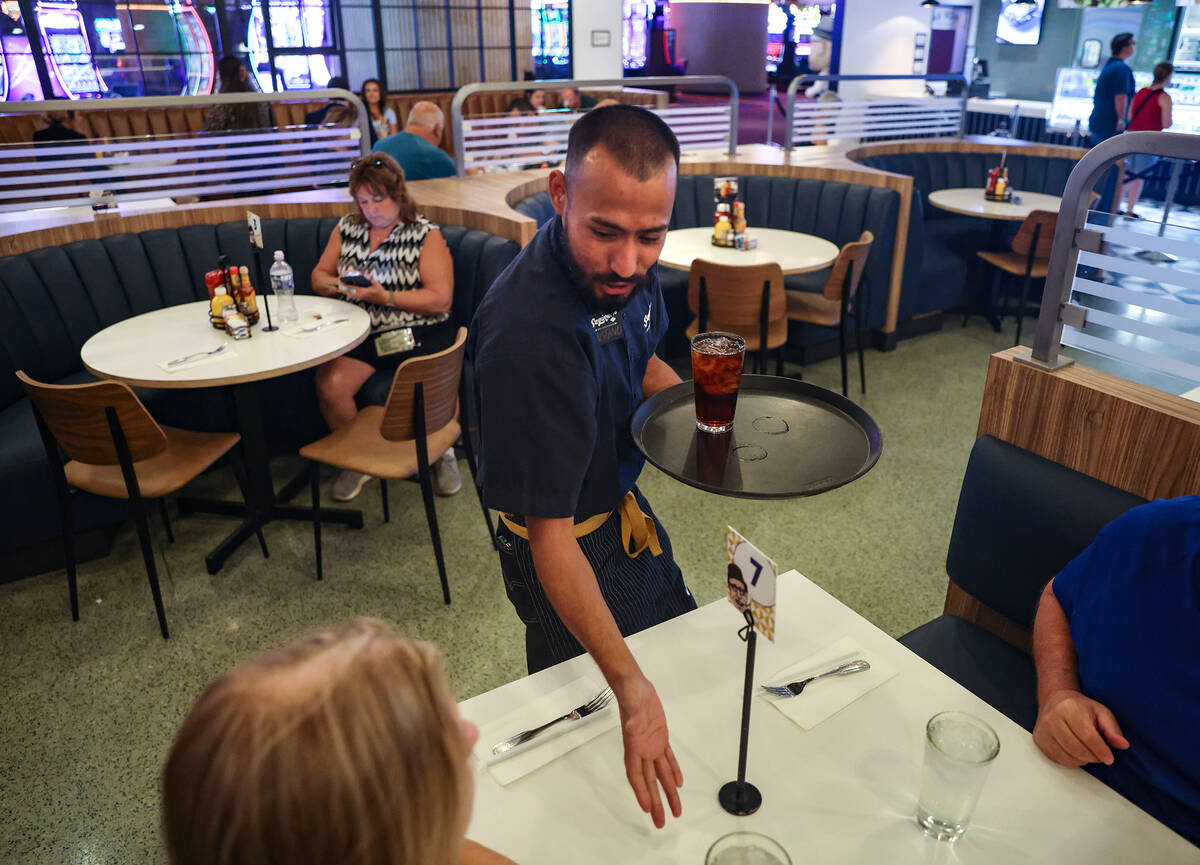 Gustavo Gutierrez delivers drinks to customers at Saginaw’s Deli at Circa hotel-casino i ...