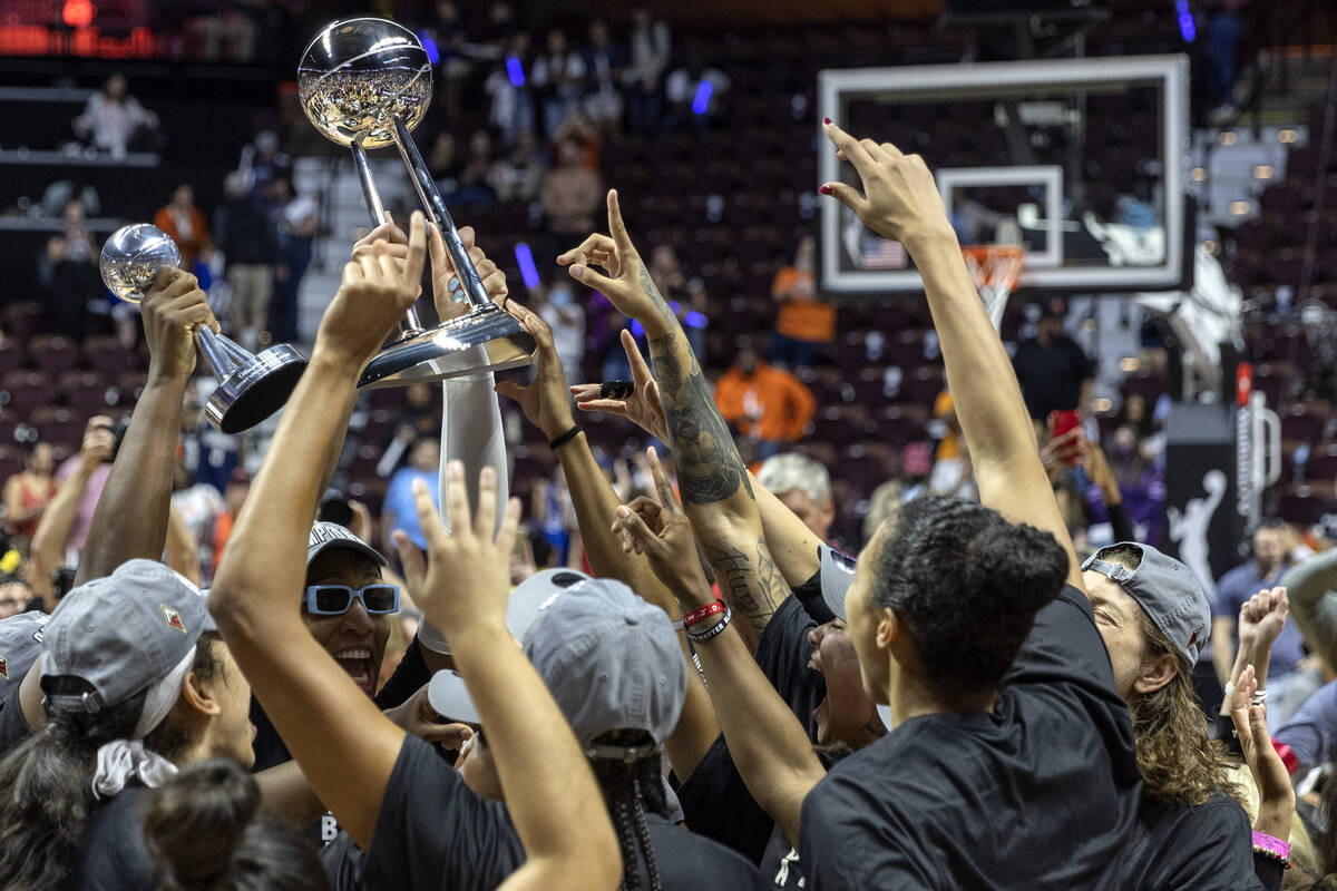 The Las Vegas Aces cheer with their new 2022 WNBA Championship trophy after winning Game 4 of a ...