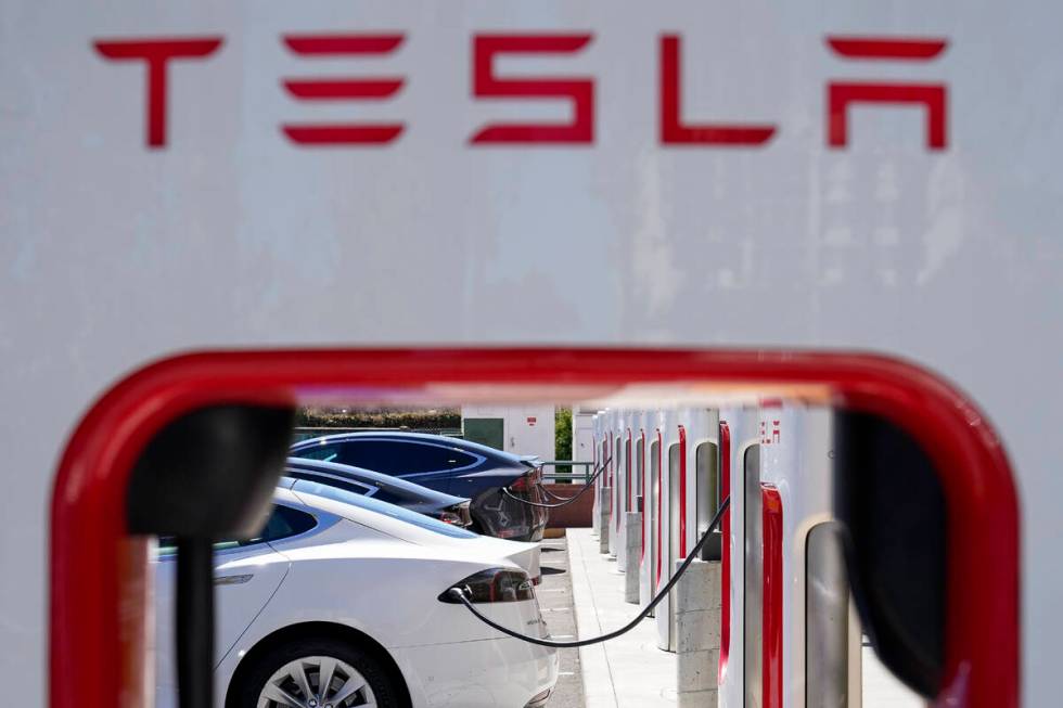 FILE - Tesla vehicles charge at a station in Emeryville, Calif., Aug. 10, 2022. Electric vehicl ...