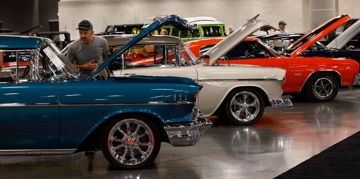 David Bauer of Sweet Home, Ore. looks at a1957 Chevrolet Bel Air Custom Coupe during the Barret ...