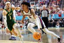 Gonzaga Bulldogs guard Julian Strawther (0) dribbles the ball to the basket under pressure from ...