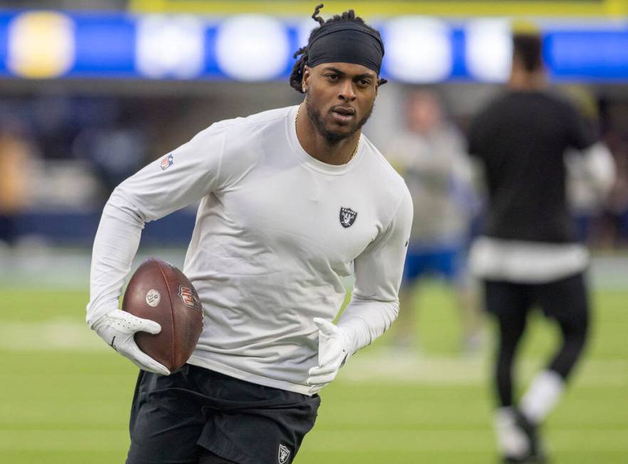 Raiders wide receiver Davante Adams (17) runs on the field before an NFL game against the Los A ...