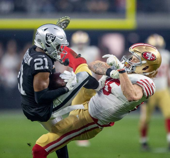 Raiders cornerback Amik Robertson (21) collides as intercepts a pass intended for San Francisco ...