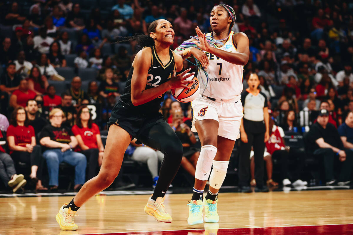 Las Vegas Aces center A’ja Wilson (22) attempts to make a basket as Indiana Fever forwar ...