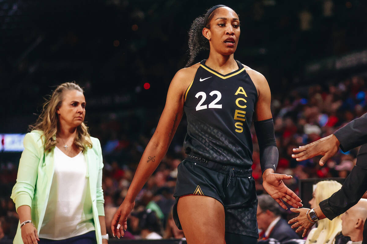 Las Vegas Aces center A’ja Wilson high fives assistant coaches and fellow teammates as s ...