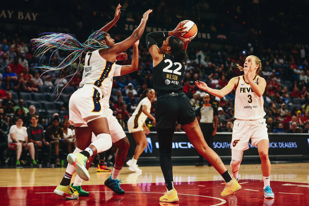 Las Vegas Aces center A’ja Wilson (22) tries to make a basket as Indiana Fever forward/c ...