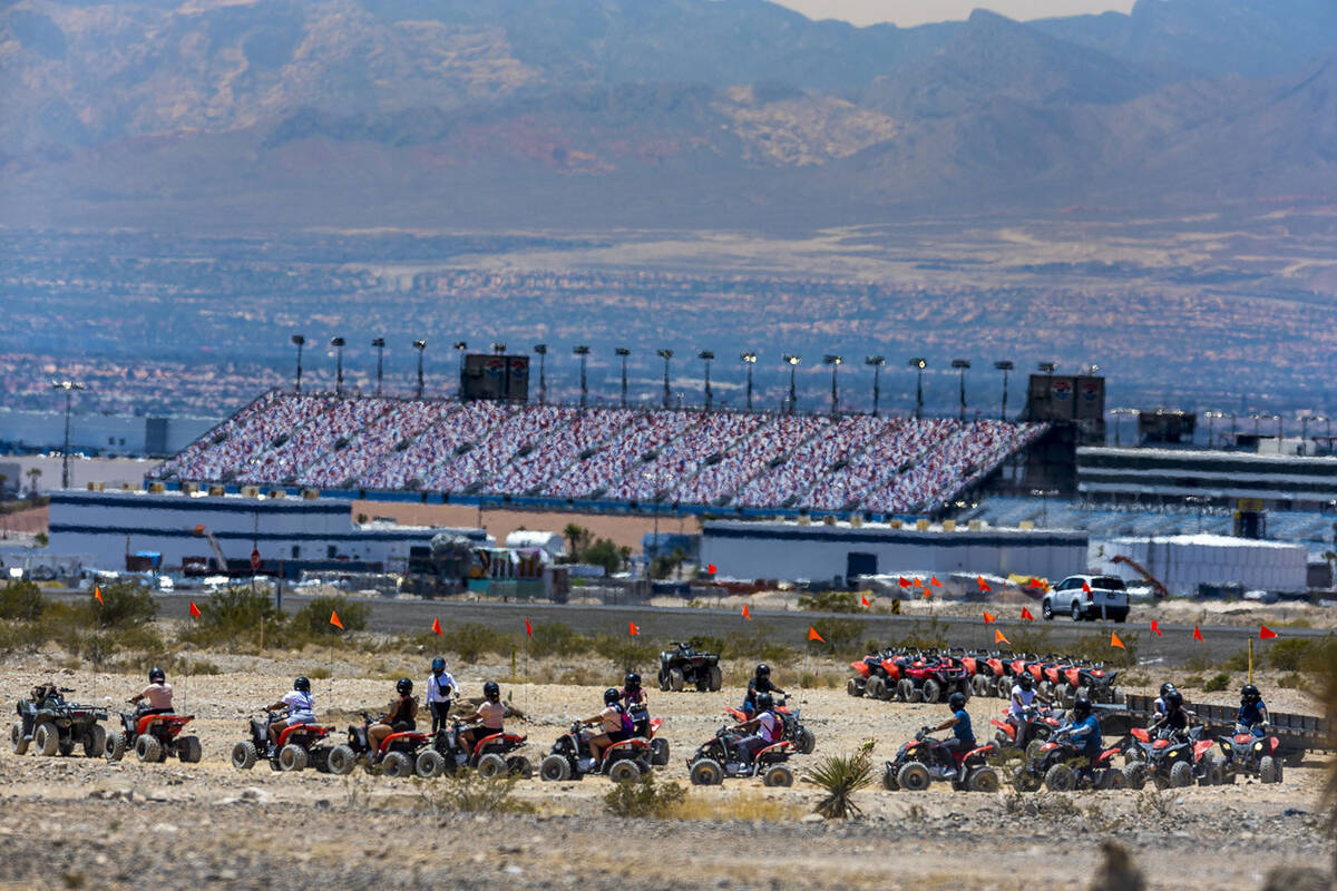 ATV riders prepare for a ride within the Nellis Dunes as hot weather moving into the valley on ...