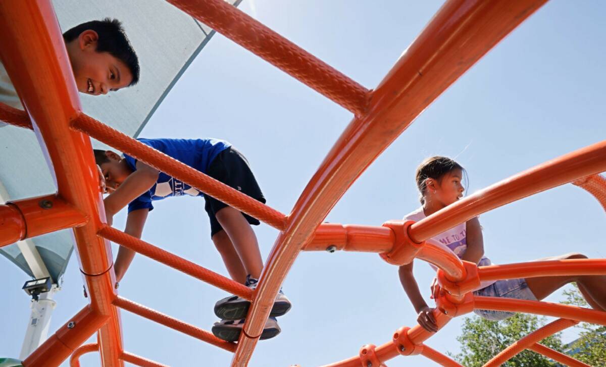 Sebastian Sotelo, 7, of Las Vegas, from left, plays with his brother Elias, 8, and his sister A ...