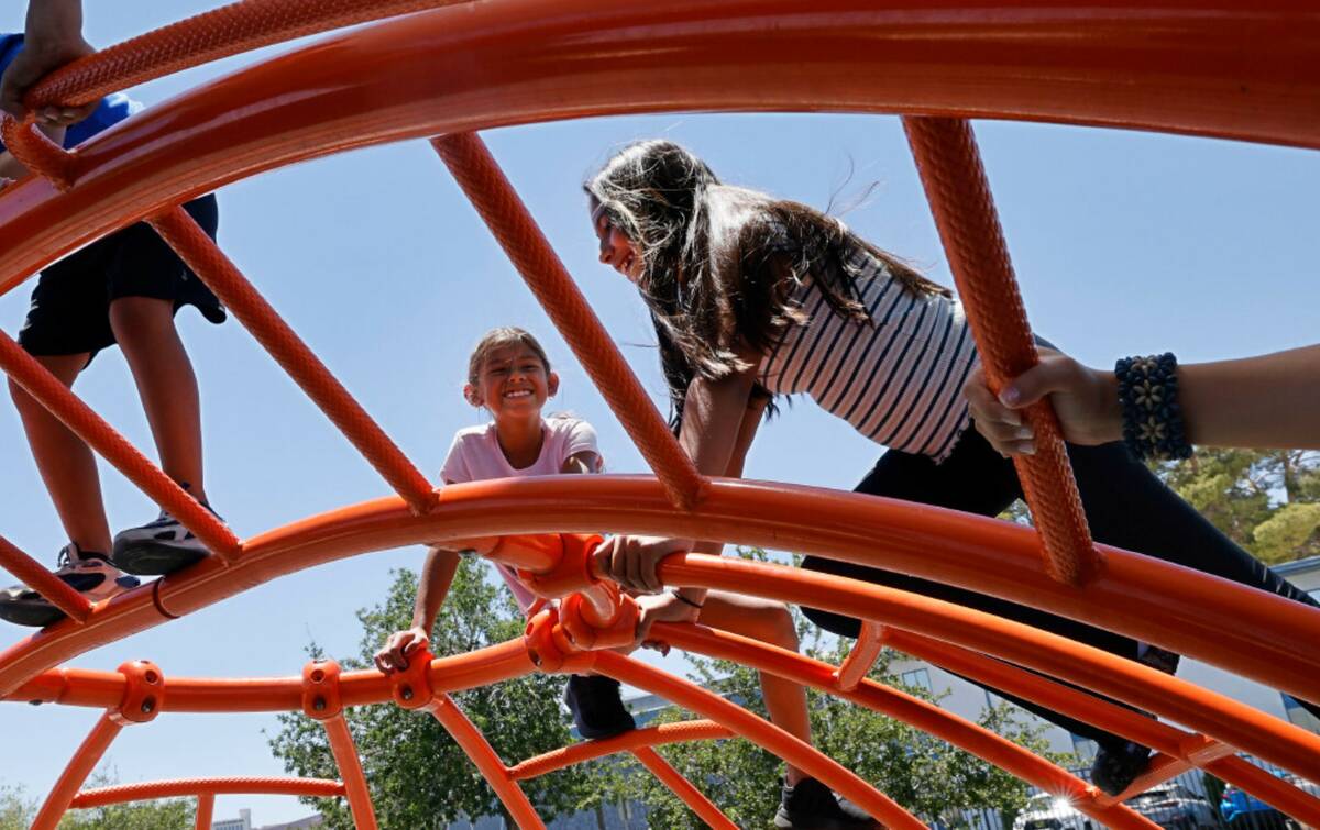 Aliayh Sotelo, 8, of Las Vegas, left, plays with her sister Jane, 11, at Baker Park, Monday, Ju ...
