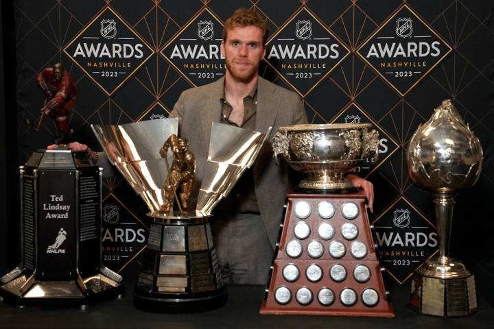 Edmonton Oilers hockey player Connor McDavid poses with the Ted Lindsey Award, the Maurice &quo ...