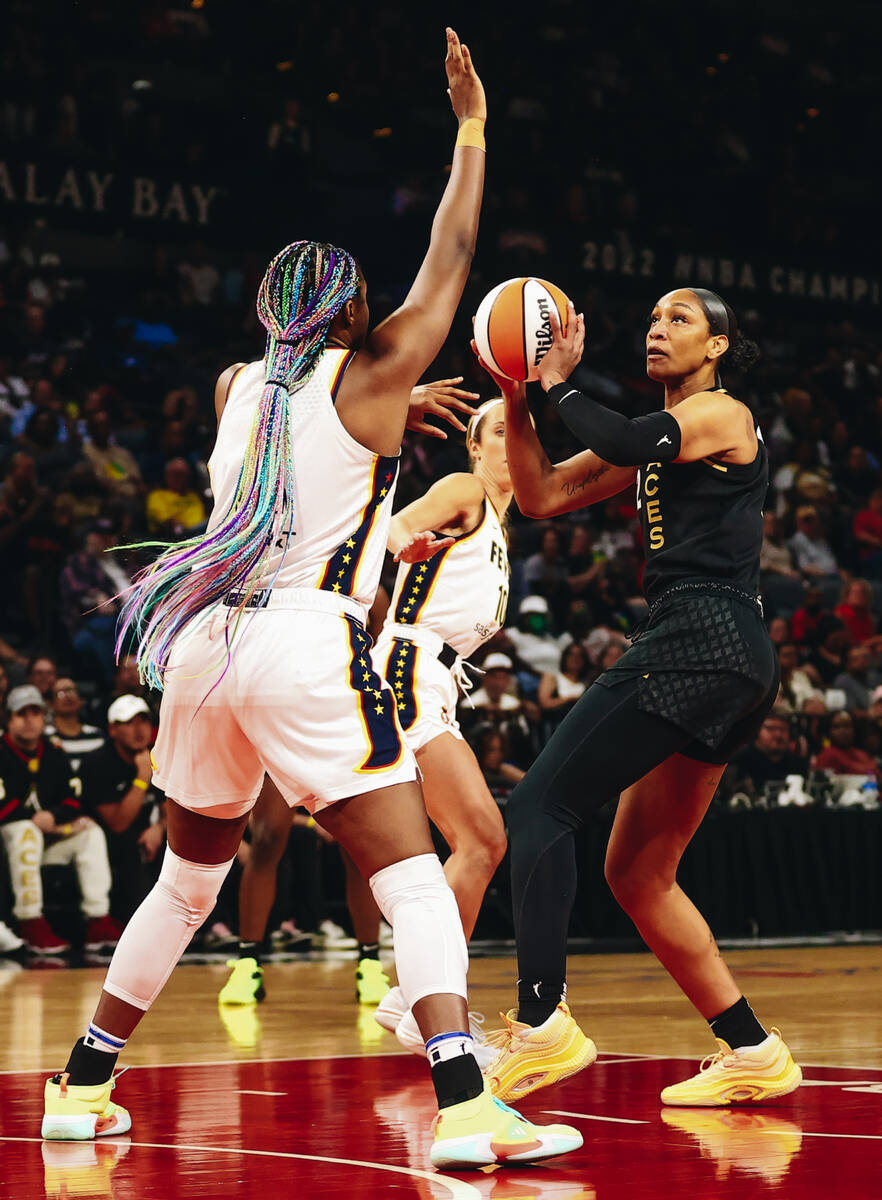 Las Vegas Aces center A’ja Wilson (right) shoots a basket as Indiana Fever forward/cente ...