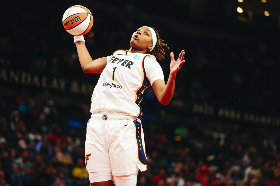 Indiana Fever forward NaLyssa Smith grabs the ball from a failed shot by the Las Vegas Aces dur ...