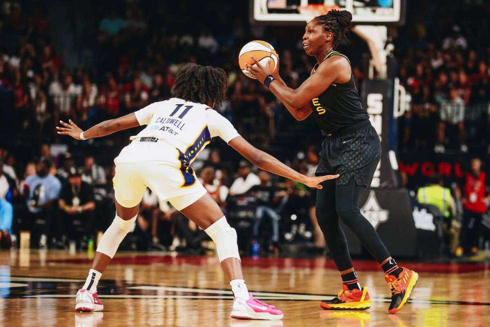 Las Vegas Aces guard Chelsea Gray (right) looks to pass the ball to a teammate as Indiana Fever ...