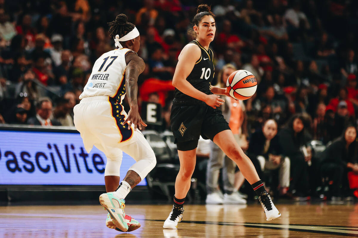 Las Vegas Aces guard Kelsey Plum (10) looks to pass the ball to a teammate as Indiana Fever gua ...