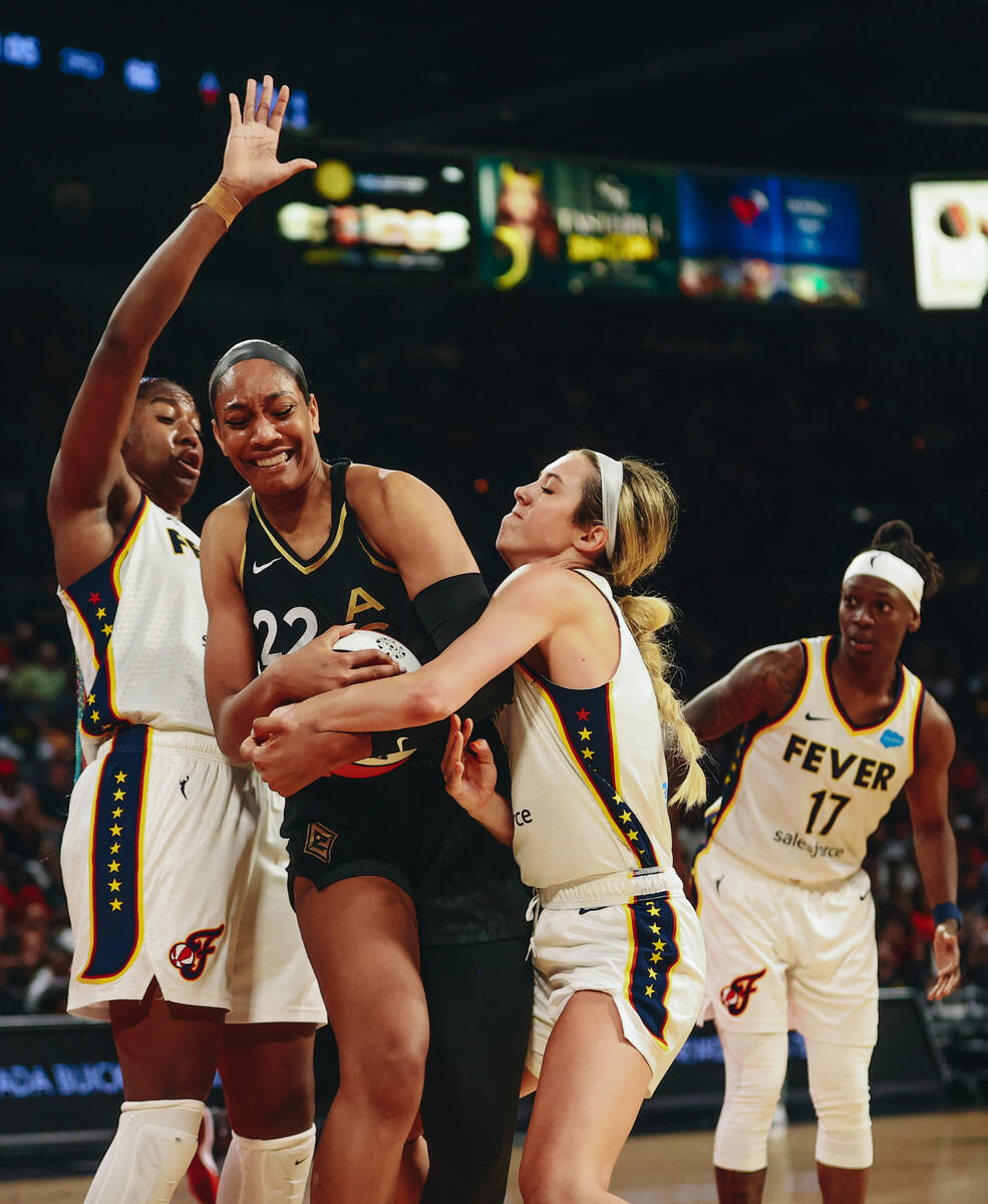 Las Vegas aces center A'ja Wilson (22) fights for possession of the ball with Indiana Fever gua ...