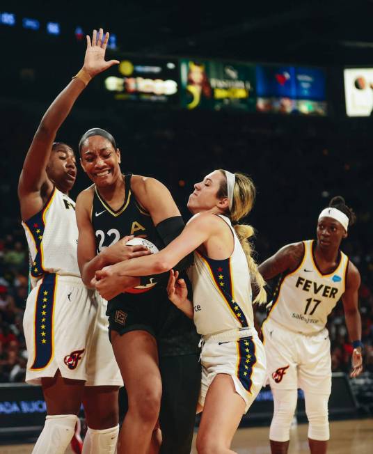 Las Vegas aces center A'ja Wilson (22) fights for possession of the ball with Indiana Fever gua ...