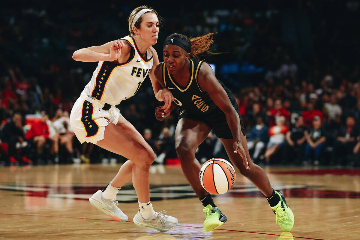 Las Vegas Aces guard Jackie young (0) dribbles the ball down the court as Indiana Fever guard L ...