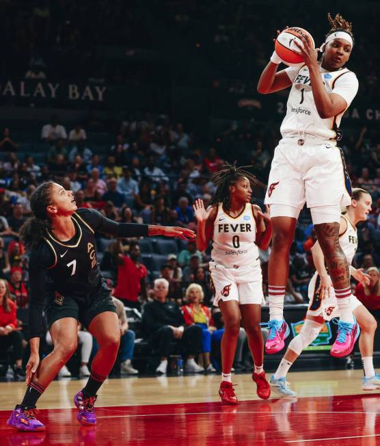 Las Vegas Aces forward Alysha Clark watches as Indiana Fever forward NaLyssa Smith (1) jumps up ...