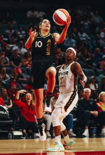 Las Vegas Aces guard Kelsey Plum goes up for a basket as Indiana Fever guard Erica Wheeler guar ...