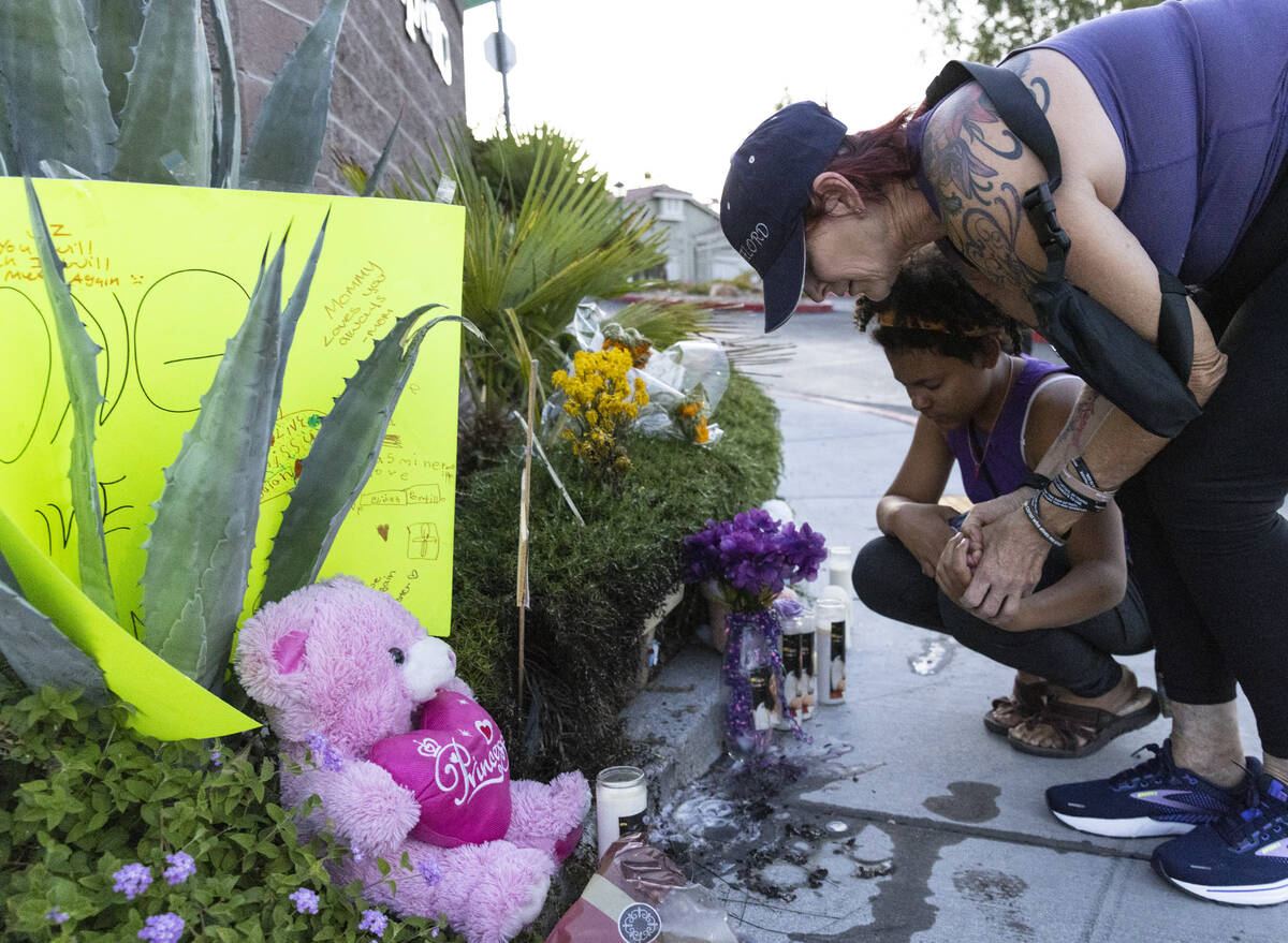 Sherry Gour and her daughter Savannah visit a roadside memorial for Jasmine Portillo, 17, durin ...