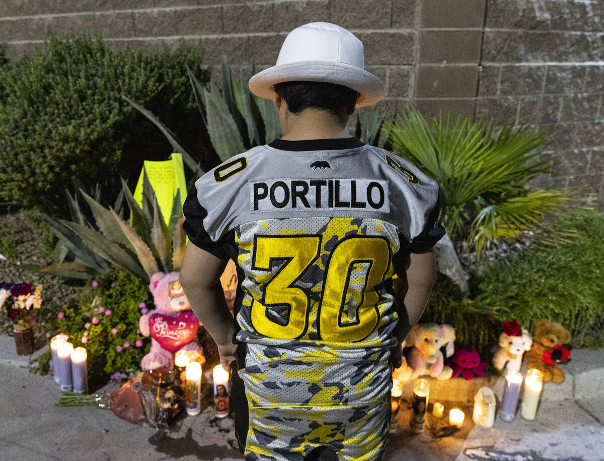 Elijah Portillo, 10, wearing his sister Jasmine Portillo's flag football jersey, visits a roads ...